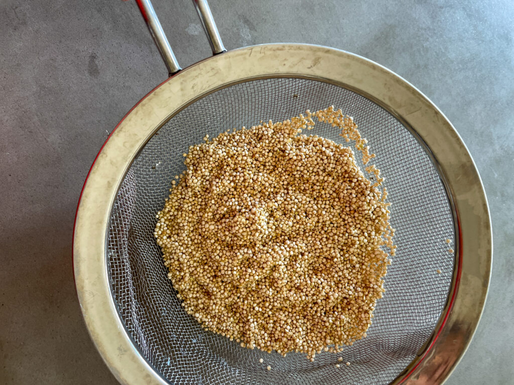 10-Minute Quinoa Tofu Veggie Scramble (Extra Protein) Quinoa in strainer