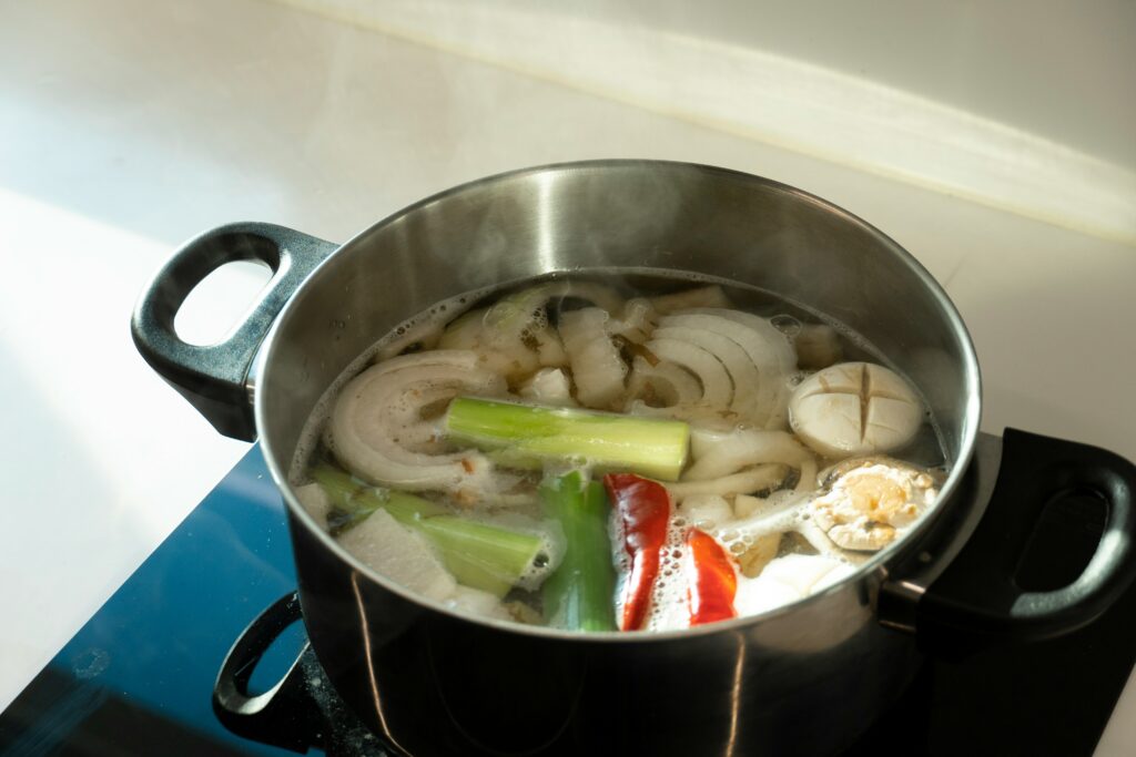 How long does vegetable broth last? Cooking vegetable broth in a large pot, simmering vegetable broth