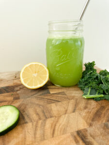 Kale Cooler Recipe, Green juice with a straw, lemon, kale and cucumber
