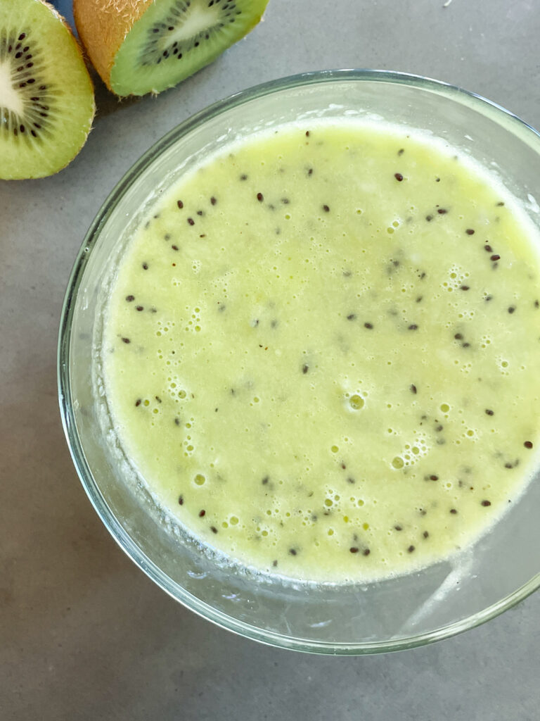 kiwi vinaigrette salad dressing in a glass bowl with fresh kiwis