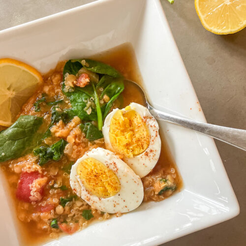 panera lentil quinoa bowl recipe with greens, boiled eggs, and a lemon slice