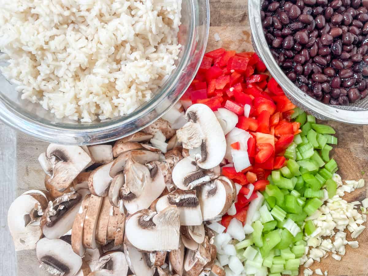 Ingredients for Black Bean Jambalaya, mushrooms, brown rice, black beans, peppers, celery and garlic