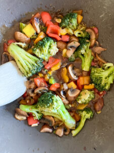 Various vegetables in a wok with stir fry sauce without soy sauce