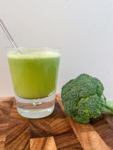 Broccoli Juicing Recipe, green broccoli juice and a head of broccoli